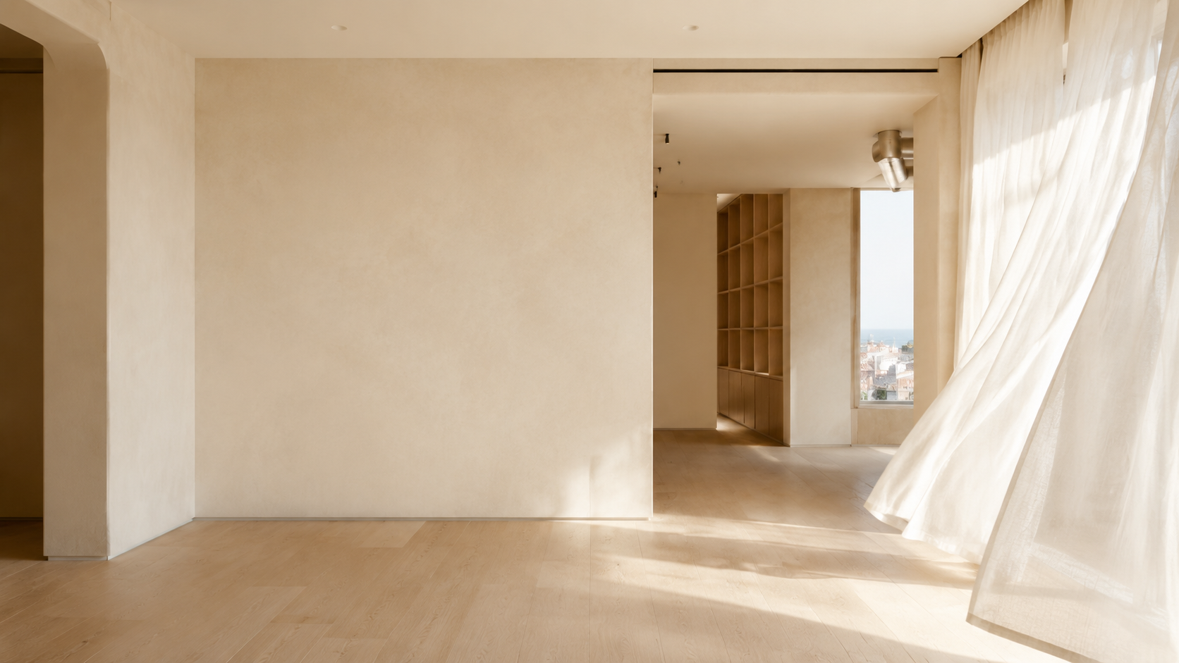 A sunlit contemporary Barcelona creative studio with moving ivory linen
